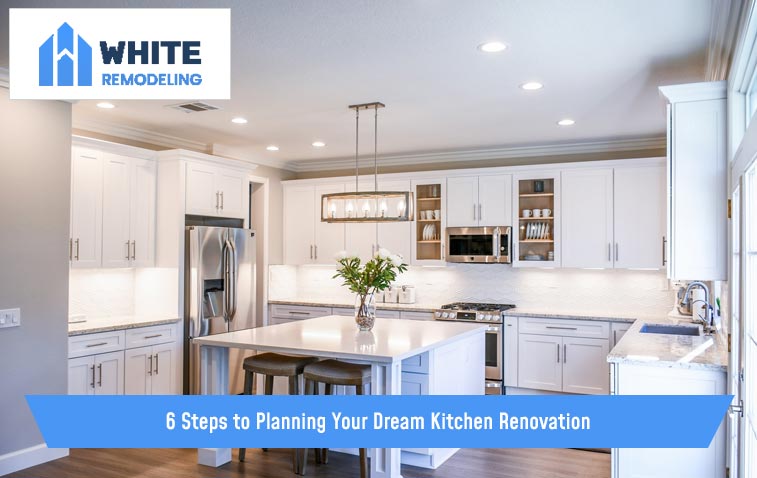 Dream kitchen with sleek cabinets, stylish lighting, and an island.