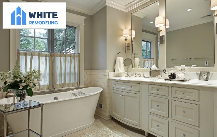 Oraganized bathroom with ample storage cabinets and drawers